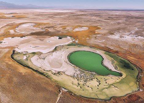 An aerial view of the otherworldly Green Lagoon and the surrounding Atacama desert.