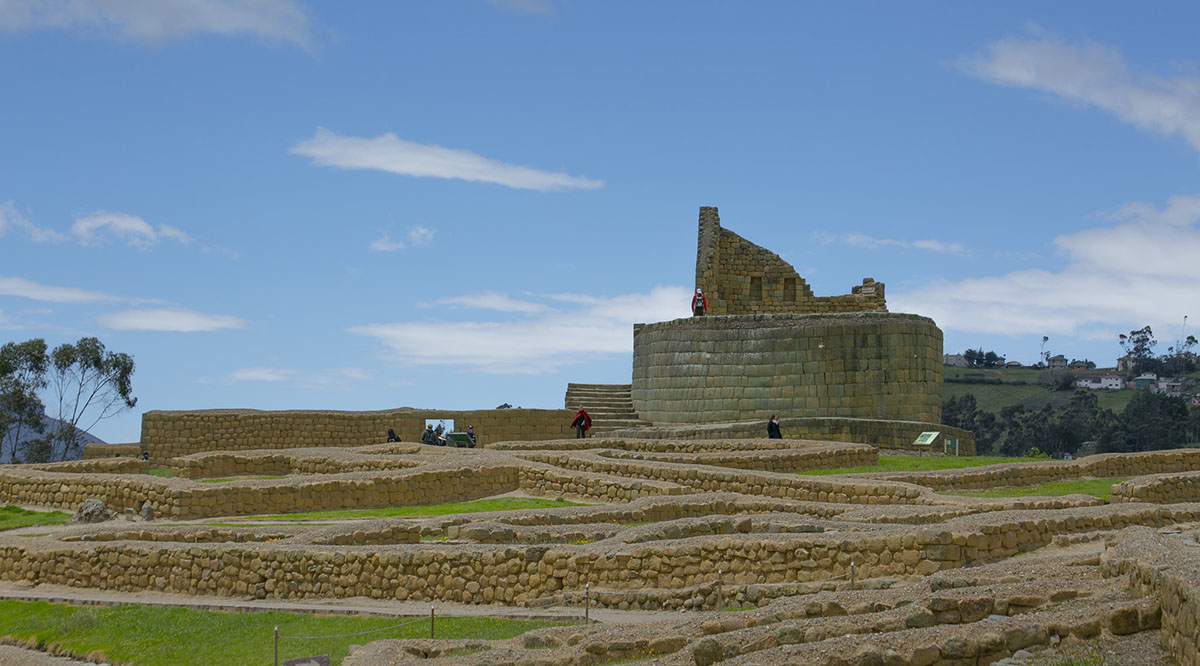 Short stone walls and a round stone building at Ingapirca ruins, the largest Inca ruins in Ecuador.