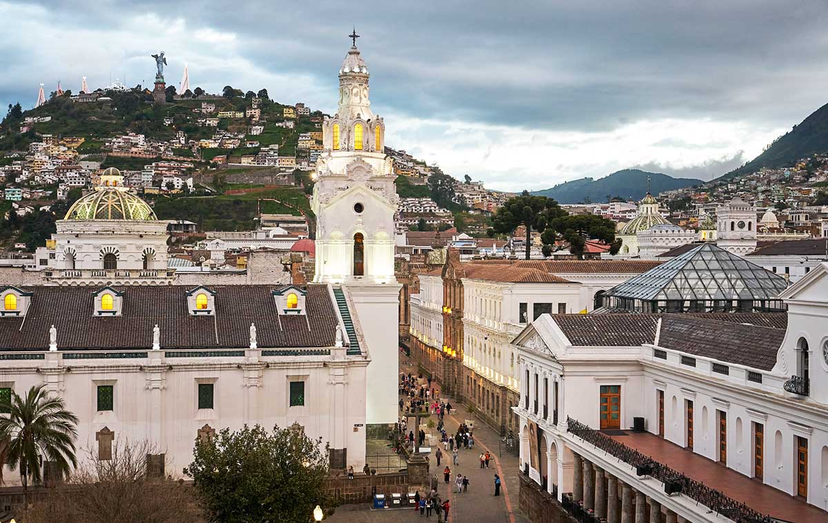 Quito’s cathedral and historic center with the Panecillo hill and virgin of Quito in the distance.