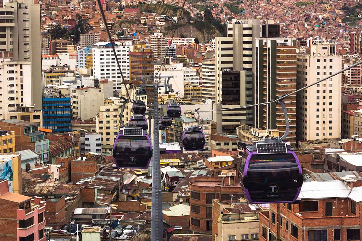 Several cable cars pass above the city of La Paz.