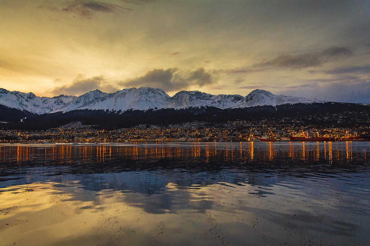 Sun setting behind Ushuaia, a top place to visit in South America.