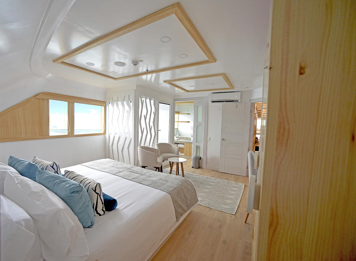 Light wood finishes and modern decor furnish a spacious cabin on the Sea Star Galapagos Cruise.