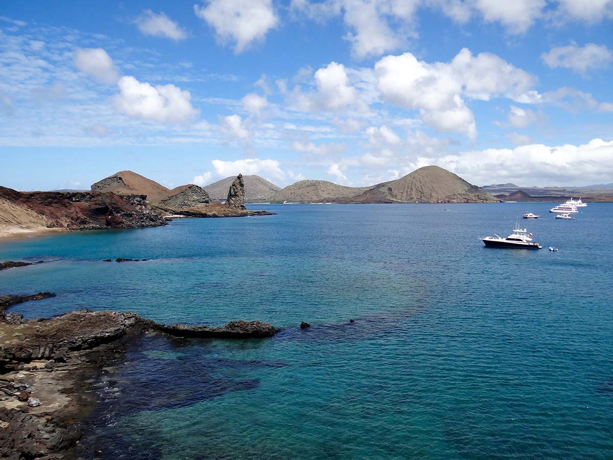 Cruise ships and yachts can be seen anchored off the shores of Playa Dorada and Pinnacle Rock