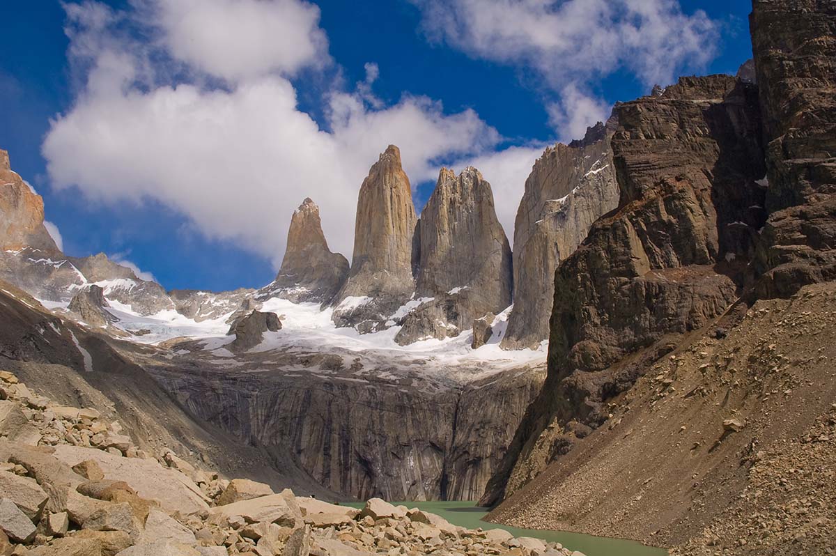 Three granite rock towers stand over a bare valley.