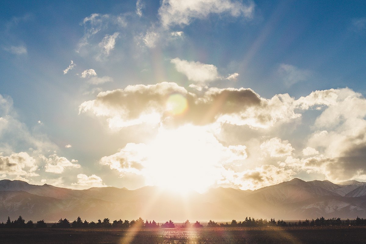 The sun setting behind mountains in Mendoza, Argentina.