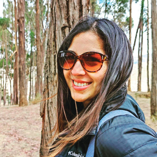 A photo of a woman with dark hair in the forest in Peru on our about us page.