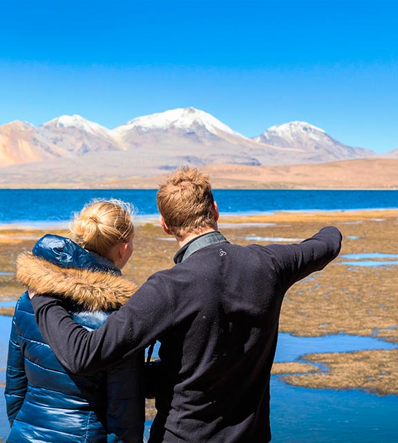 A couple visiting Laguna Chaxa, one of the many scenic lagoons near Chile's San Pedro de Atacama.