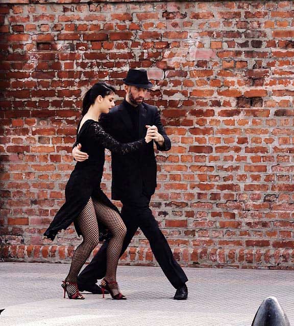 A couple of dancers performing the tango, the most iconic dance of Buenos Aires.