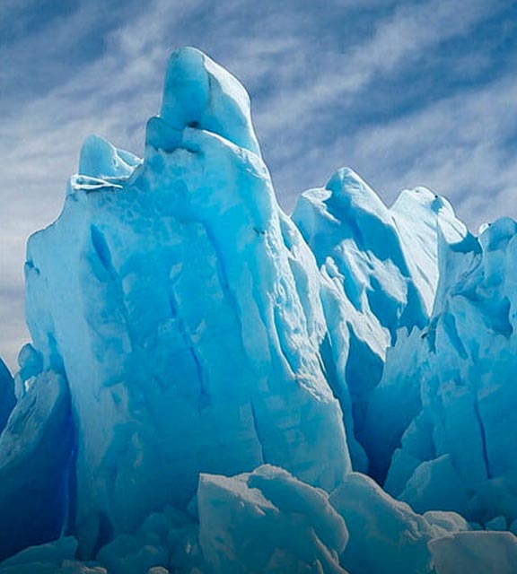 The turquoise blue Perito Moreno glacier in El Calafate sits in the still waters of Lake Argentina.