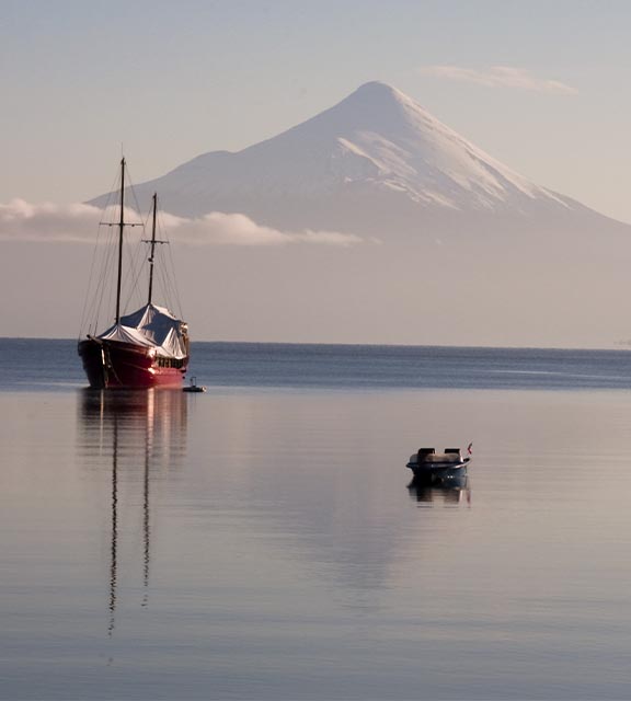 Boats in the water near Puerto Montt, with the massive Osorno Volcano visible in the background.