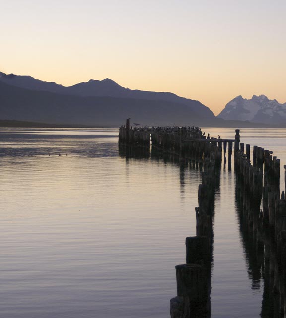 A wooden pier extending into the Almirante Montt Gulf near Puerto Natales in Chilean Patagonia.