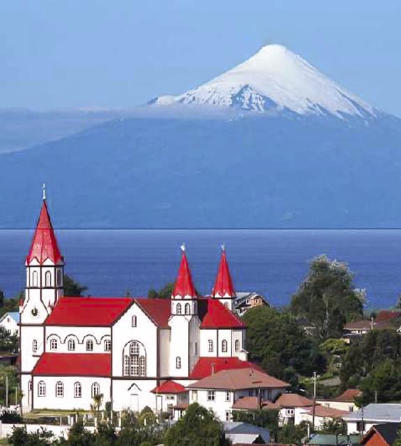 A snow-capped volcano overlooking the neo-Romanesque Church of the Sacred Heart in Puerto Varas.