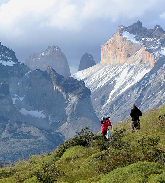 A couple of hikers stopping for a photo on the trek to Torres del Paine in Chilean Patagonia.