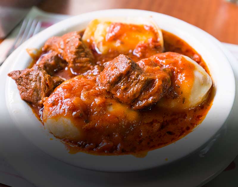 A plate of sorrentinos con salsa bolognesa, one of the many hearty dishes available in El Calafate.