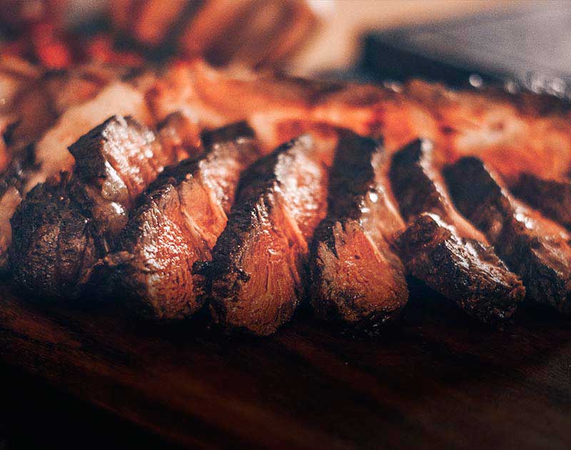 A perfectly-cooked medium rare steak cut into strips at a restaurant in Florianopolis.
