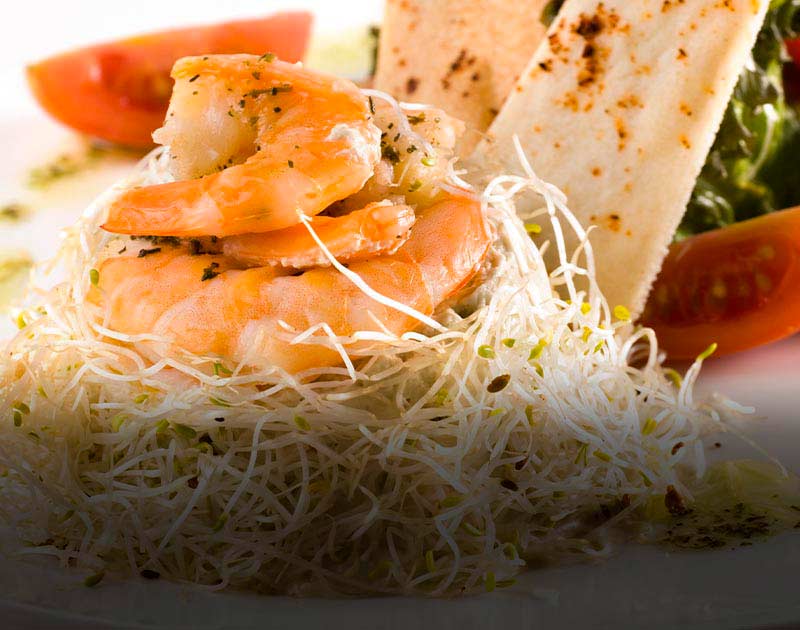 A plate of shrimp on a bed of bean sprouts at a restaurant in the Chilean city of Iquique.