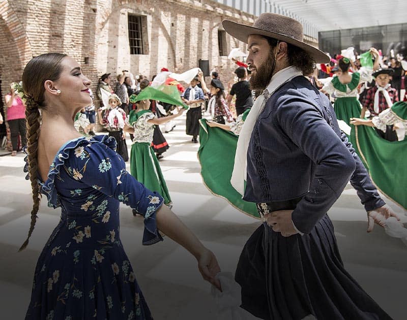 A couple wearing traditional dress while performing a folkloric dance in Mendoza.