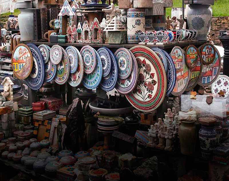 Various artisan handicrafts and souvenirs on sale at a small market stand in Ouro Preto.