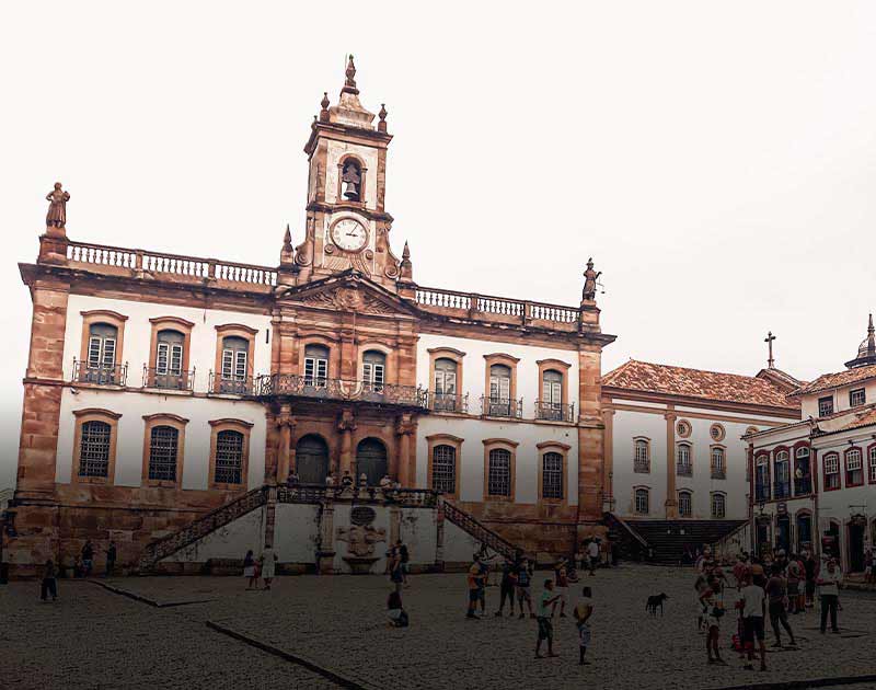 Crowds of visitors standing in the plaza in front of the Museum of the Inconfidência in Ouro Preto.