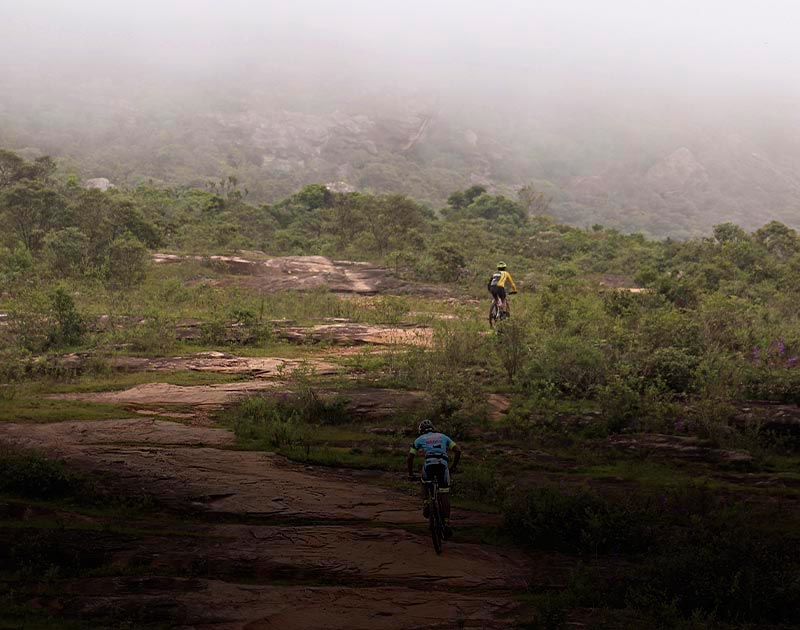 Two mountain bikers riding on a trail through Andorinhas State Park near Ouro Preto.