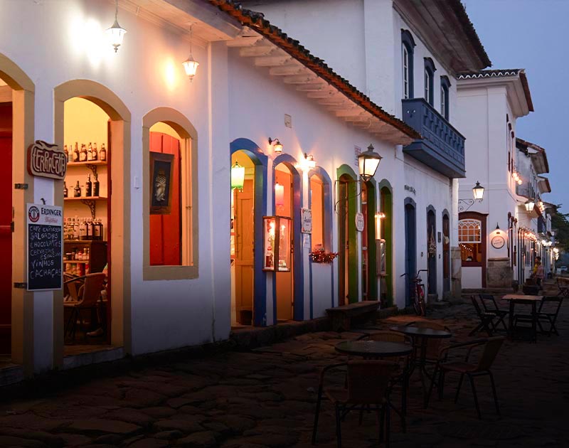 Bars and cafes located along a cobblestone road inside historic buildings in Paraty’s old town.