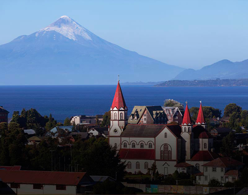 The Osorno Volcano overlooking the Church of the Sacred Heart and Lake Llanquihue in Puerto Varas.