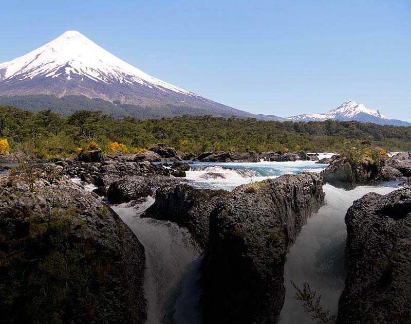 The Petrohue Waterfalls overlooked by the snow-capped Osorno Volcano near Puerto Varas.