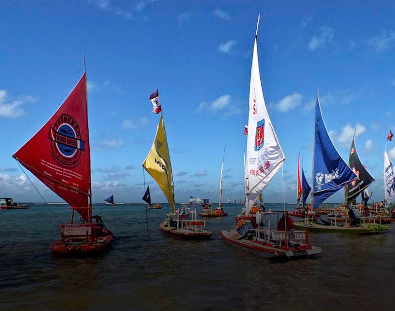 Sailboats with different colored sails in the water at Porto de Galinhas near Recife.