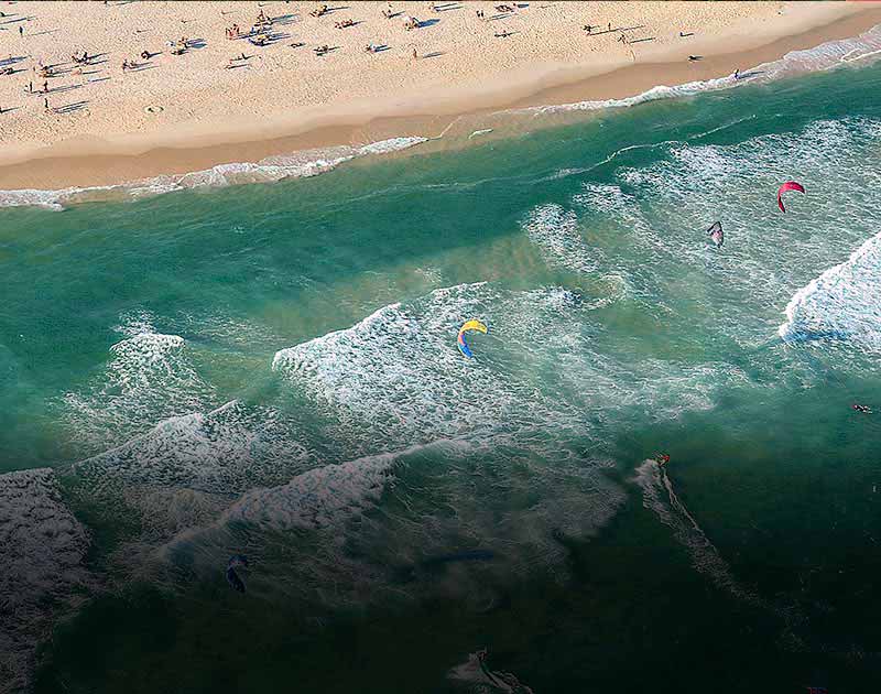 An aerial view of kitesurfers enjoying the waters just off the beach in Rio de Janeiro.