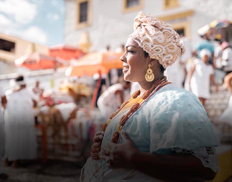 A Bahiana woman wearing traditional clothing, jewelry and head covering in Salvador.