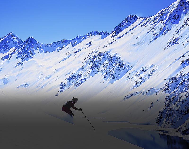 A skier skiing down a snow-covered mountainside at the Portillo Ski Center near Santiago.
