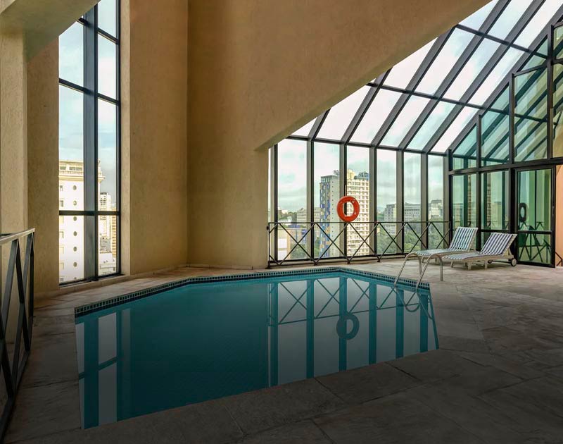 A small indoor pool with a view of the Sao Paulo skyline at the Radisson Hotel Oscar Freire.