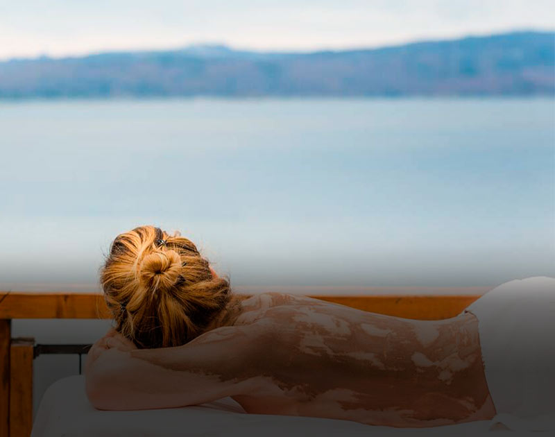 A woman enjoying a wellness treatment at the Hotel Los Cauquenes, a luxury hotel in Ushuaia.