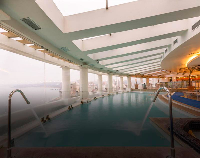 A luxurious indoor pool with a gorgeous view of the coast at a hotel in Viña del Mar.