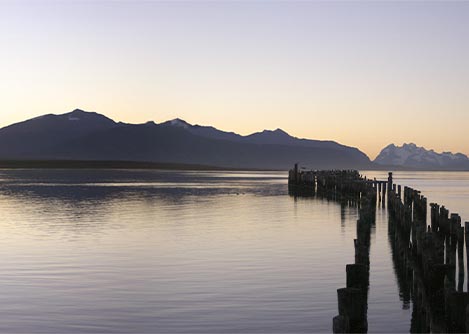A wooden pier extending into the Almirante Montt Gulf near Puerto Natales in Chilean Patagonia.