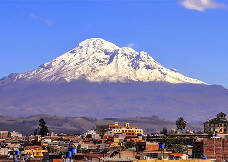 The iconic snow-capped Volcano Chimborazo overlooking the city of Riobamba in Ecuador.