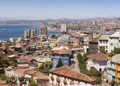 An aerial view of the city of Valparaiso with some of the city’s classic houses in the foreground.