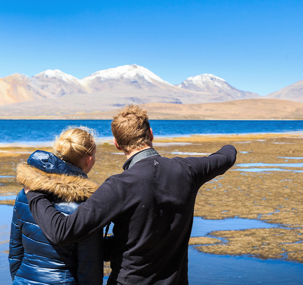 A couple visiting Laguna Chaxa, one of the many scenic lagoons near Chile's San Pedro de Atacama.
