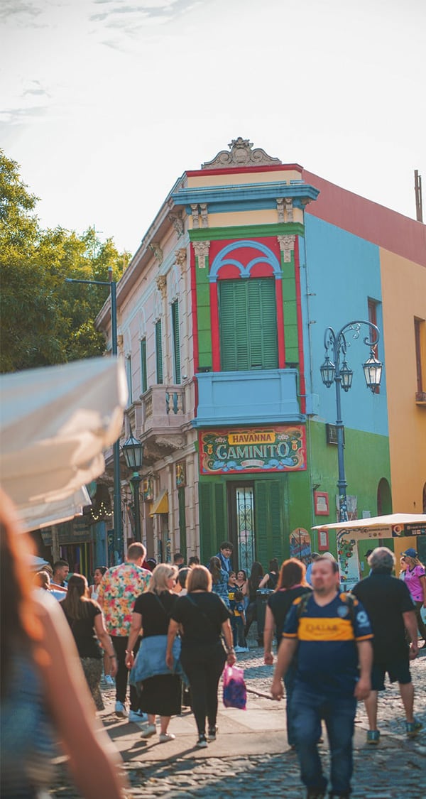 Visitors walking down the cobblestone streets of the Caminito district in Buenos Aires.