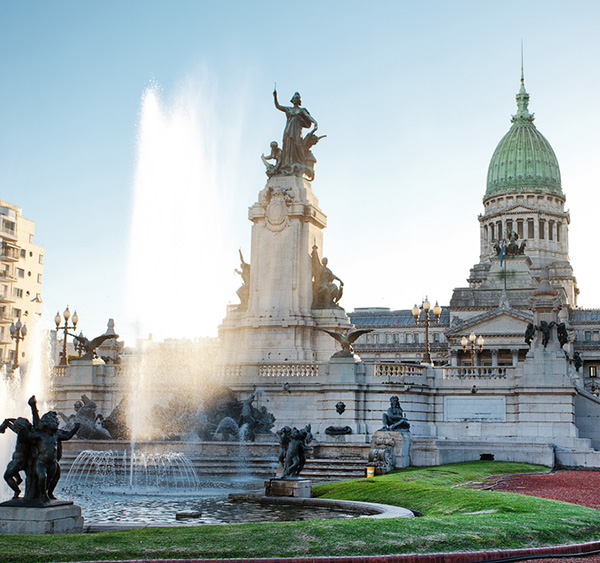 A water fountain and statues in front of the Palace of the Argentine National Congress.