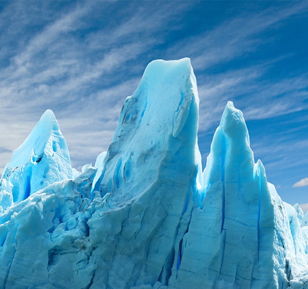 Jagged spires of a  blue-tinted glacier in Los Glaciares National Park in Argentina.