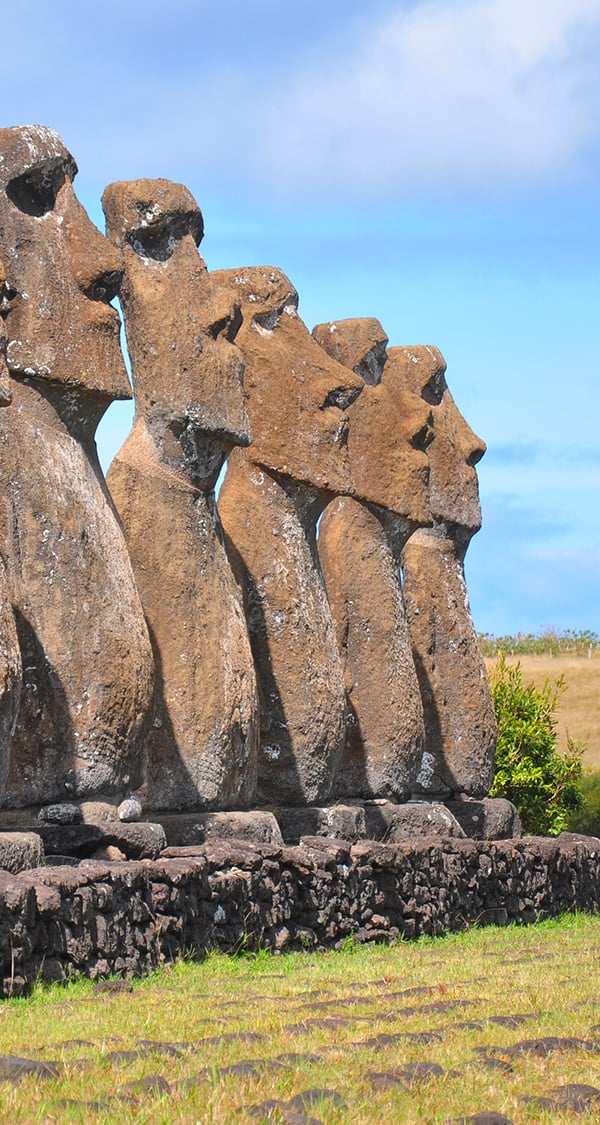 A row of moais, the human figures made of stone left by the inhabitants of Easter Island.