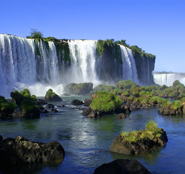 Moss-covered rocks and a waterfall in one section of Iguazu Falls in Argentina.