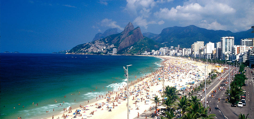 A sunny day with lots of people at one of Rio de Janeiro's world-famous beaches.