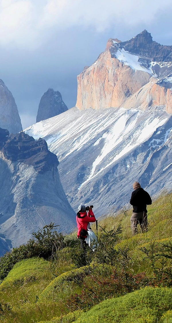 A couple of hikers stopping for a photo on the trek to Torres del Paine in Chilean Patagonia.