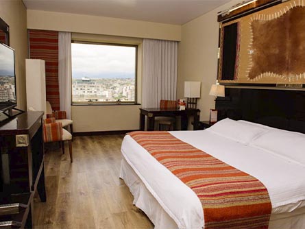 An elegantly-decorated room at the Alejandro 1 Hotel with a view of Salta from the window.