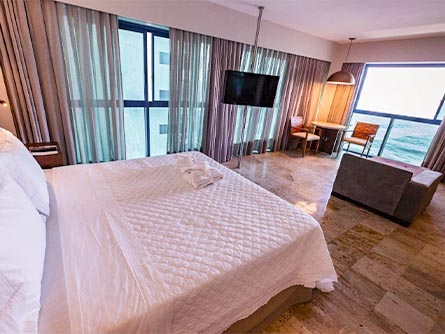 A spacious room with an elegant, modern design at the Atlante Plaza Hotel in Recife.