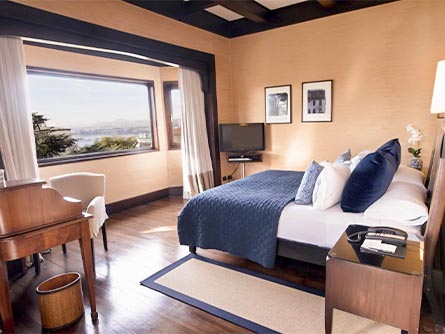 A cozy room with wood flooring and a beige and blue motif at the Casa Higueras in Viña del Mar.