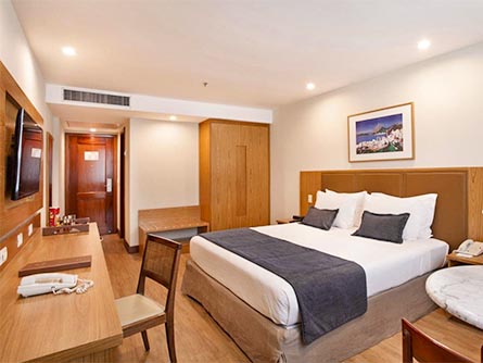A beautiful room with wood flooring and furniture at the Excelsior Copacabana Hotel in Rio.
