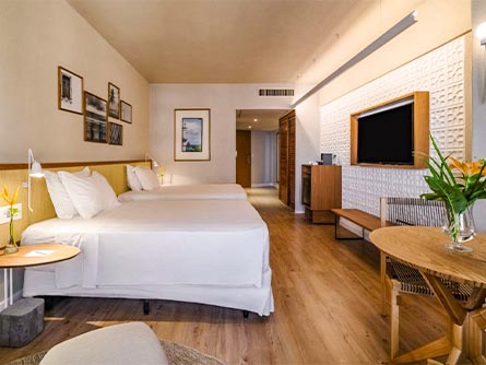 A beautiful room with wood flooring and modern design at the Golden Tulip Palace in Recife.